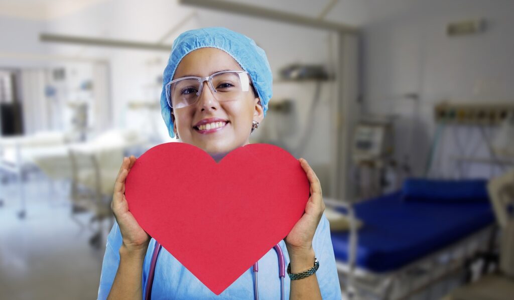A nurse holding a paper heart ‣ iands Nurses and other healthcare providers can earn 21 continuing education contact hours through iands