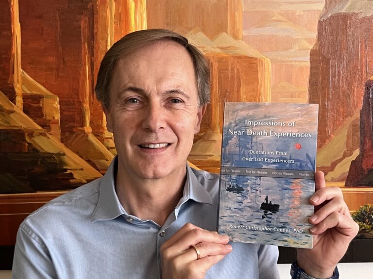 Author Bob Coppes poses with his book Impressions of Near-Death Experiences Quotations from Over 100 Experiencers